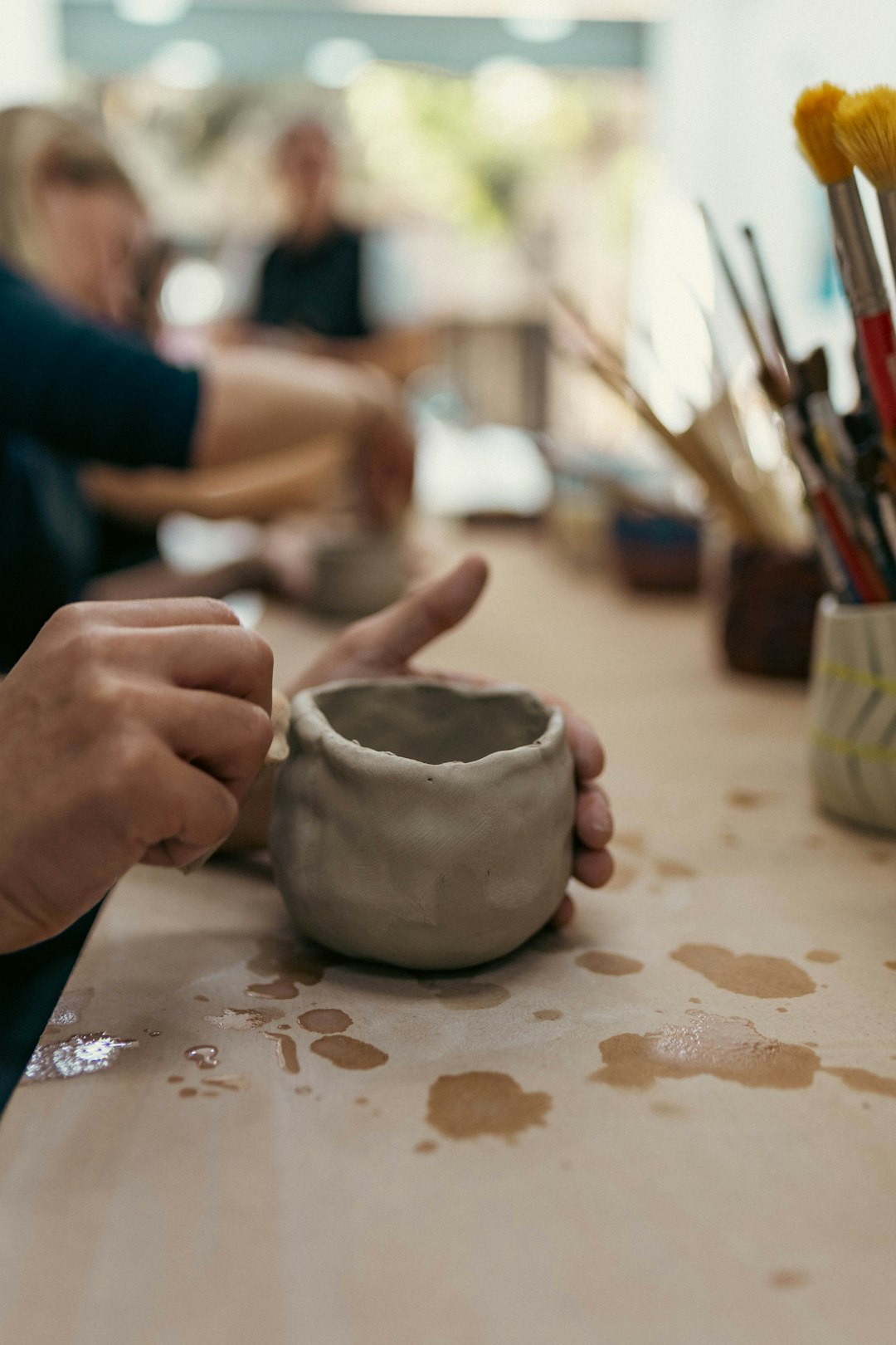 A person sitting at a table with a cup in front of them